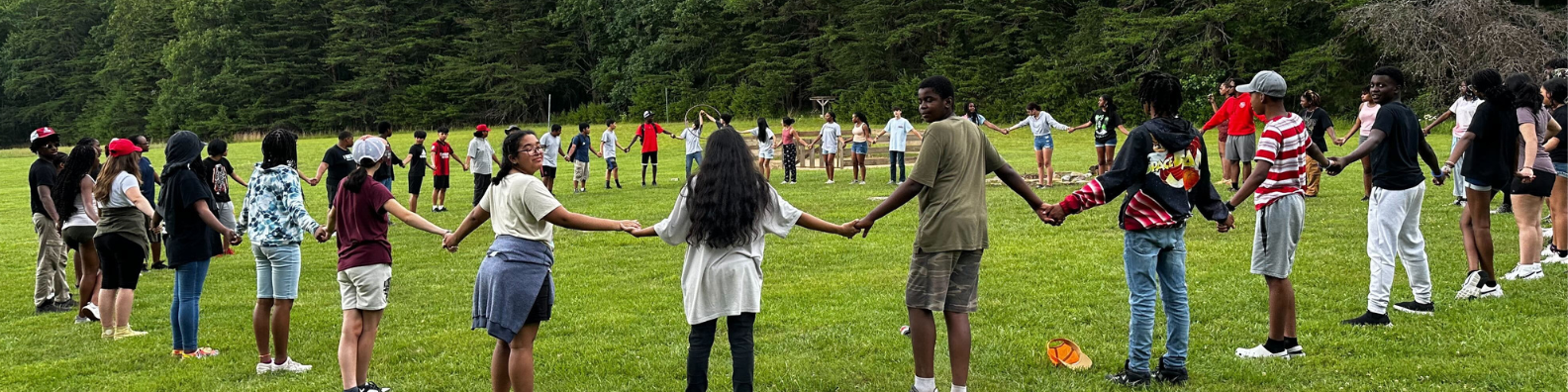 Youth leaders in a circle in a meadow